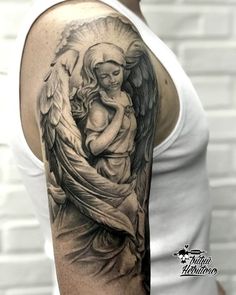 a man with a tattoo on his arm is holding an angel in his arms and looking at the viewer