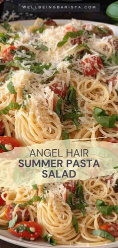 an angel hair pasta salad with tomatoes, basil and parmesan cheese on top