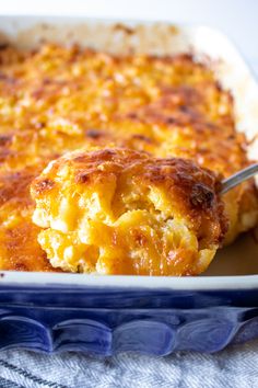 a close up of a casserole on a plate with a spoon in it