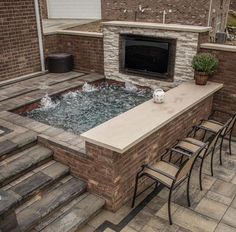 an outdoor hot tub with chairs around it