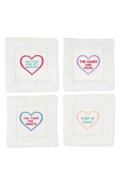 four napkins with embroidered hearts on them