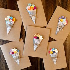 six pieces of paper with flowers in them on top of brown envelopes and papers