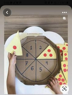 someone is making a paper clock out of cardboard