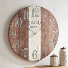 a clock that is on the wall next to a jar and some jars in front of it