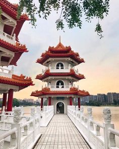 a white and red building sitting next to a body of water