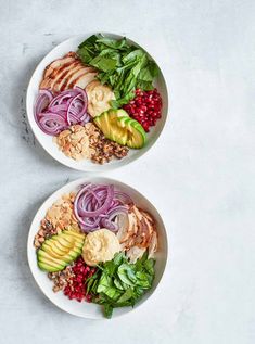 two white bowls filled with food on top of a gray table next to each other