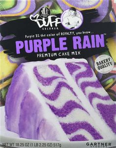 a purple cake with white frosting and zebra print on the top is in front of a package