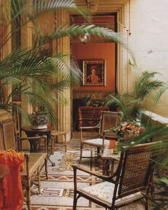 a living room filled with lots of furniture and plants