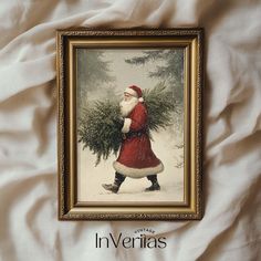 a santa clause carrying a christmas tree on his back with the words invertias above it