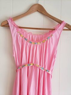 This is a vintage, Kaiser, babydoll nightgown. This nightgown is pink with floral applique accents. The garment is loose cut and the sash is meant to cinch it in. It is a size small. There is a pinhole in the back as you can see in the images. The price reflects this. All sales are final. This was made in the USA. The tag is marked irregular. The measurements are as follows: Armpits: 23.5 inches Hem: 30.5 Length from top of strap: 37 inches Don't forget to stop in at my other Etsy shop... http:/ Feminine Pink Nightgown For Bedtime, Spring Pink Nightgown For Pajama Party, Pink Spring Nightgown For Sleep, Pink Summer Nightgown For Bedtime, Pink Sleeveless Nightgown For Bedtime, Pink Lace Trim Nightgown For Loungewear, Pink Lace Trim Dress For Loungewear, Vintage Pink Sleepwear, Pink Lace Trim Sleepwear For Bedtime