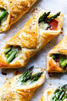 asparagus, tomato and cheese pastries on parchment paper