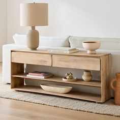 a living room scene with focus on the coffee table and vases in the foreground