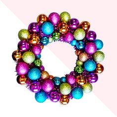 a colorful christmas ornament on a pink and white background with the letter o