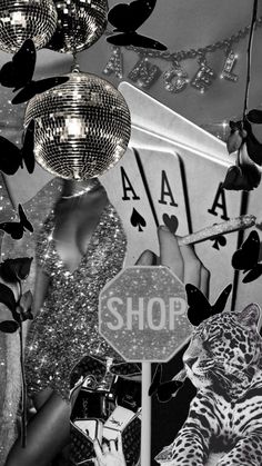 a black and white photo of a woman holding up a mirror ball