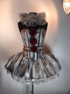 a dress made to look like it is being worn by a mannequin with red flowers on the bust