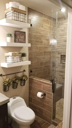 a bathroom with a toilet, shower and shelves on the wall next to each other