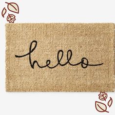 a door mat with the word hello written on it in cursive black ink