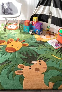 a child's playroom with toys and rugs on the floor in front of a teepee tent