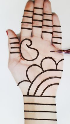 a person's hand with lines drawn on it and a pen in the palm