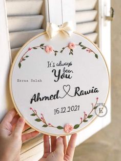 someone is holding up a personalized wedding ornament