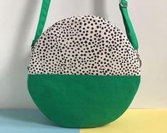 a green and white purse sitting on top of a table