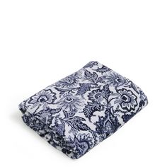 a blue and white floral print blanket on a white background