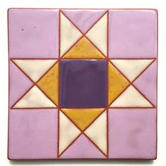 a purple and yellow tile with an orange center