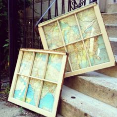 two old maps are sitting on the steps next to each other, with one leaning up against the railing