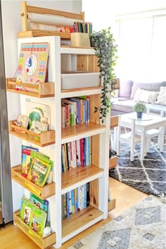 a bookshelf filled with children's books in a living room