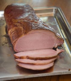 a large piece of meat sitting on top of a metal tray