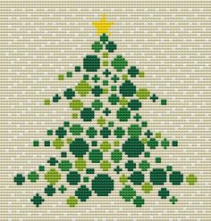 a cross stitch christmas tree with shamrocks on it