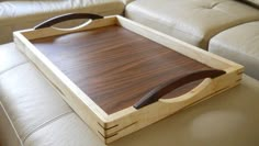 a wooden tray sitting on top of a couch