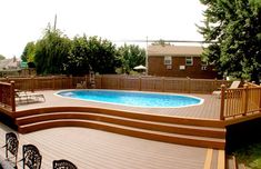 a wooden deck next to a pool with chairs around it and an above ground swimming pool