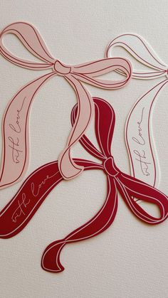 some red and pink ribbons with writing on them