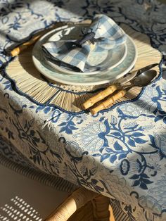 a blue and white table setting with place settings