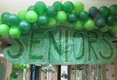 balloons and streamers adorn the entrance to a new year's celebration