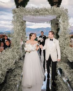 a bride and groom walking down the aisle