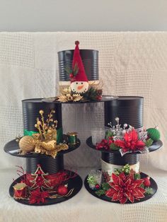 a stack of tin can christmas hats on top of each other with poinsettis