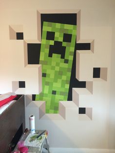 a room with a bed and a wall painted like the creeper from minecraft