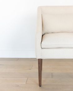 a white chair sitting on top of a hard wood floor