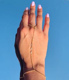 "18 Karat Gold Filled CZ Hand Chain Bracelet length:  Option A: 7\" + 1.5\" Extension Option B: 6.5\" - 3mm Beaded Bracelet Option C: 7\" + 1.5\" Extension Finger Loop: 4\"  Material: 18 Karat Gold Filled, Hypoallergenic. Tarnish Resistant. Gold-filled does not de-laminate or peel like Gold plated Jewelry nor does it tarnish as readily as silver. Generally speaking, gold filled is better quality and will have a much longer lasting color than plated jewelry. Gold filled jewelry is an excellent op Adjustable Crystal Gold Rings, Adjustable Chain Bracelet For Wedding, Delicate Adjustable Gold Body Jewelry, Elegant Adjustable Body Jewelry With Gold Chain, Elegant Adjustable Gold Chain Body Jewelry, Minimalist Adjustable Crystal Jewelry, Adjustable Metal Jewelry For Promise, Delicate Adjustable Jewelry With Bracelet Strap, Dainty Chain Body Jewelry For Wedding