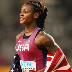 a female athlete with an american flag on her shoulder