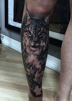 a person with a cat tattoo on their leg