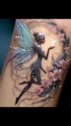 a tattoo with a fairy on it and flowers in the background, as well as an image