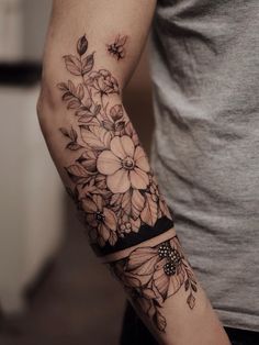 a man with a flower tattoo on his arm