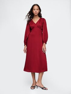 Soft satin midi dress.  Lace-trim V-neck.  Long sleeves.  Empire waist.  Slit at the hem.  Fit: Slim.  An A-line silhouette that sits close to the body with a flared opening.  Hits below the knee.  Models wearing Gap Holiday Midi Dress, Red Modest Dress, Christmas Party Dress Cocktail, Long Sleeve Red Dress, Flowy Fashion, Closet Outfits, Long Flowy Dress, Winter Palette, Thanksgiving Dress