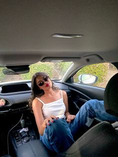 a woman sitting in the back seat of a car