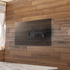 a bathroom with wood paneling and a white sink in front of a mirror on the wall