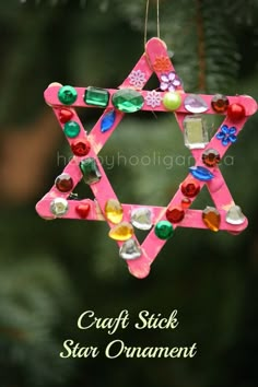 a pink ornament hanging from a christmas tree with the words craft stick star on it