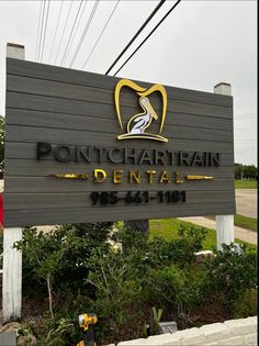 a wooden sign for a dental office with a bird on it's head and the words pontchatrin dental